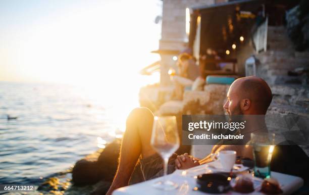 young man enjoying the summertime by the sea - holiday camp stock pictures, royalty-free photos & images