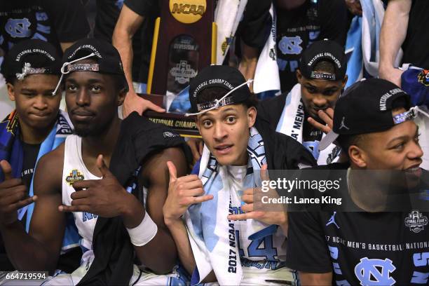 Theo Pinson, Justin Jackson and Nate Britt of the North Carolina Tar Heels celebrate with teammates following their 71-65 victory against the Gonzaga...