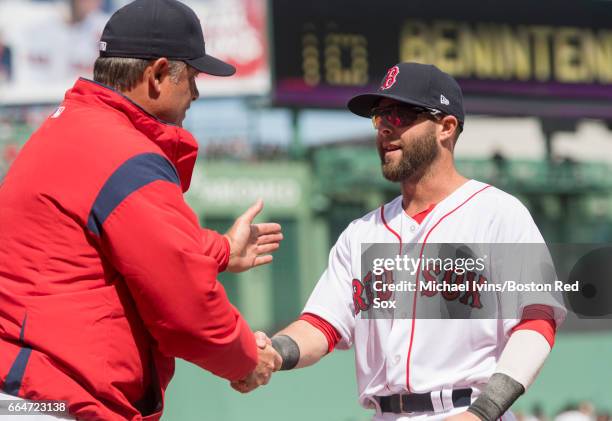 Dustin Pedroia of the Boston Red Sox shakes hands with manager John Farrell during team introductions before an opening day game against the...