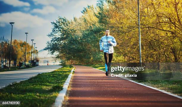 jogging in the morning. - jogging track stock pictures, royalty-free photos & images
