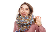 Happy female holding bottle with medicament