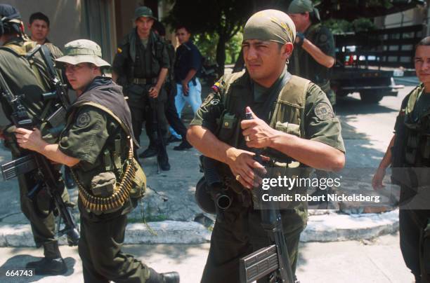 Federal Police officers prepare to go on patrol in a FARC controlled barrio August 21, 2000 of Barrancabermeja, Colombia. Barrancabermeja has the...