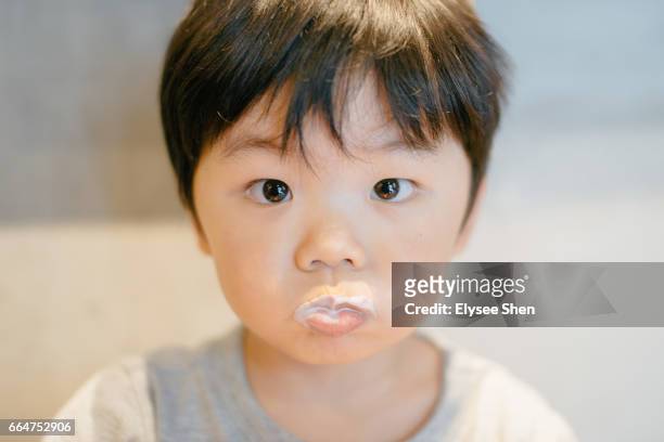 a chinese boy in coffee shop drinking milk - shanghaiface stock pictures, royalty-free photos & images