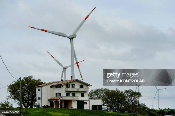 House with a very close wind tower in Montelongo wind farm in Molise, southern Italy. One of the biggest wind farms of southern Italy for the...