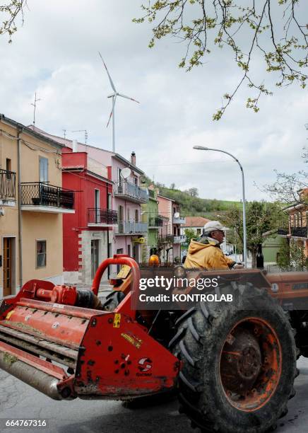 Citizen with tractor in Montelongo town near Montelongo wind farm in Molise, southern Italy. One of the biggest wind farms of southern Italy for the...