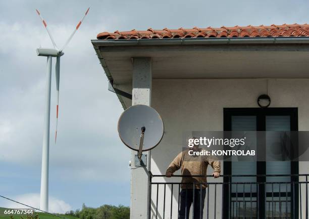 Citizen in his house near a turbine of Montelongo wind farm in Molise, southern Italy. One of the biggest wind farms of southern Italy for the...