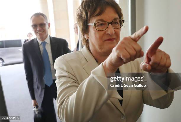 German Economy and Energy Minister Brigitte Zypries gestures to walk past photographers as she and PSA Peugeot Citroen CEO Carlos Tavares arrive at...