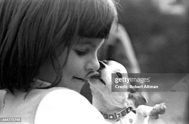 Child with a dog has her face licked circa February, 1969 at Golden Gate Park in San Francisco, California.