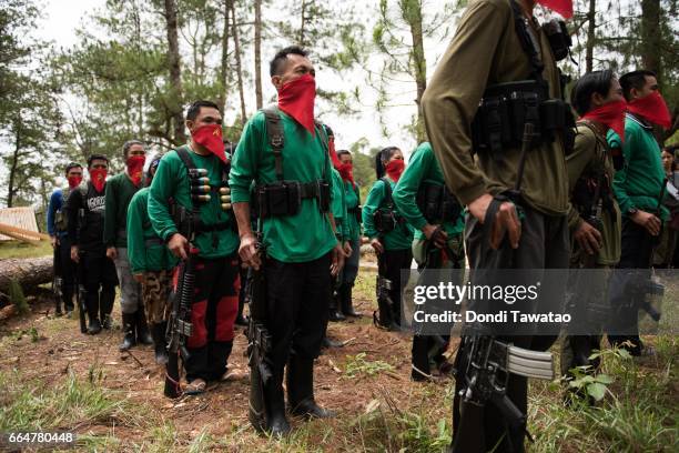 Platoon of guerilla fighters from the Chadli Molintas Regional Command march in formation during simple rites commemorating the 48th year anniversary...