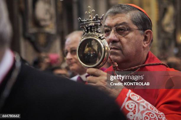 The archbishop of Naples Crescenzio Sepe shows to the crowd of worshippers the ampulla that contains the liquefied blood of San Gennaro during the...