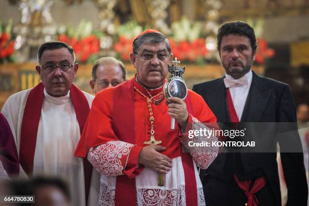 The archbishop of Naples Crescenzio Sepe shows to the crowd of worshippers the ampulla that contains the liquefied blood of San Gennaro during the...