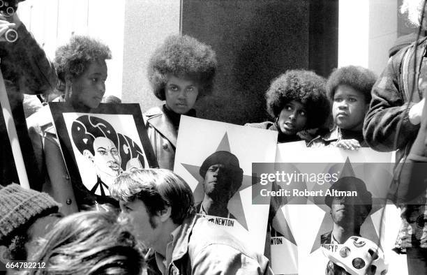 Group of women show their support for the Black Panther Party while holding signs with the picture of Minister of Defense Huey P. Newton on May 1,...