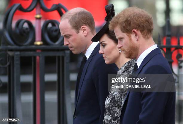 Britain's Prince William, Duke of Cambridge, Britain's Catherine, Duchess of Cambridge and Britain's Prince Harry stand during a wreath layer...