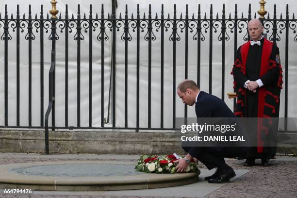 Britain's Prince William, Duke of Cambridge lays a wreath prior to a Service of Remembrance at Westminster Abbey in central London on April 5...