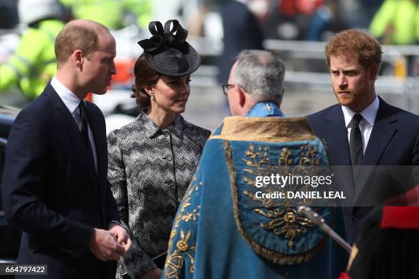 Britain's Prince William, Duke of Cambridge, , Britain's Catherine, Duchess of Cambridge, and Britain's Prince Harry are greeted by John Hall, Dean...