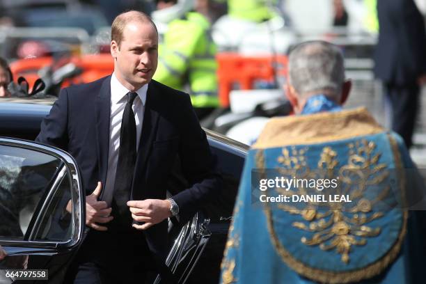 Britain's Prince William, Duke of Cambridge is greeted by John Hall, Dean of Westminster on his arrival to attend a Service of Remembrance at...