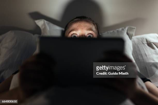 woman using home tablet pc. - horror stock pictures, royalty-free photos & images