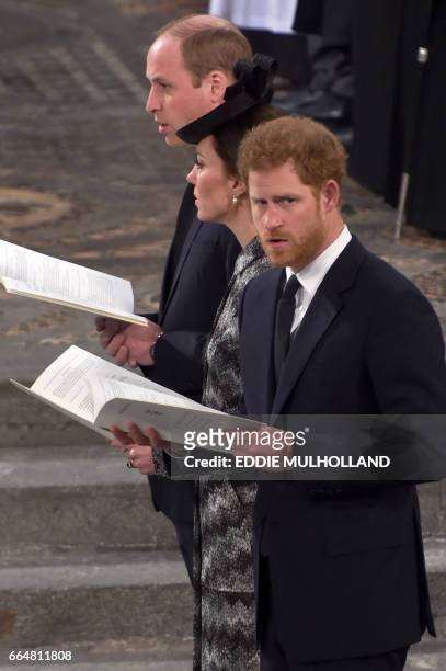 Britain's Prince William, Duke of Cambridge, Britain's Catherine, Duchess of Cambridge and Britain's Prince Harry attend a Service of Remembrance at...