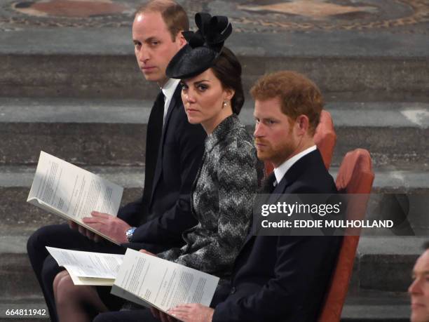 Britain's Prince William, Duke of Cambridge, Britain's Catherine, Duchess of Cambridge and Britain's Prince Harry attend a Service of Remembrance at...