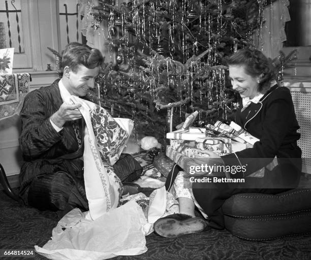 Betty Lou Oliver, the ‘Sunshine Girl,’ and her husband, Oscar Oliver, admire the Christmas tree in the home of Betty Lou’s aunt, Mrs. Helen E. Gower....