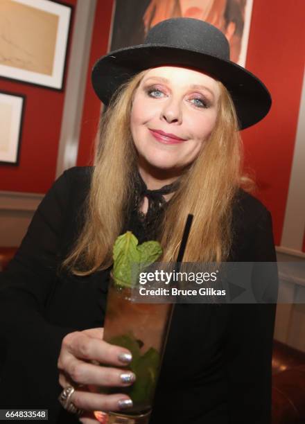 Bebe Buell poses with the "Bebe Buell cocktail" as she visits the HGU New York's 1905 Lounge at the HGU New York Hotel on April 4, 2017 in New York...