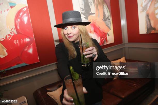 Bebe Buell poses with the "Bebe Buell cocktail" as she visits the HGU New York's 1905 Lounge at the HGU New York Hotel on April 4, 2017 in New York...
