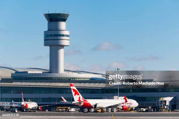 air canada rouge plane and the air traffic control tower in pearson international airport- toronto,canada - toronto pearson international airport stock pictures, royalty-free photos & images