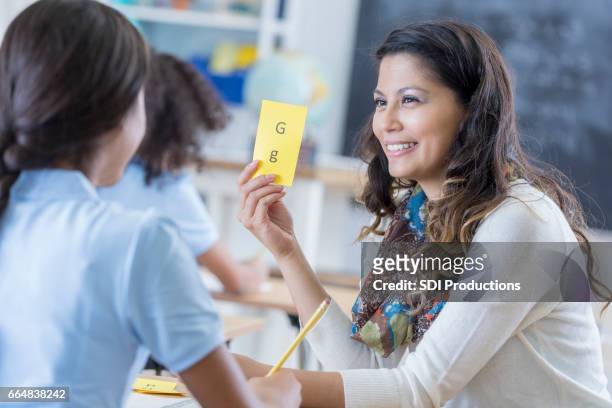 confident teacher works with student - flash card stock pictures, royalty-free photos & images