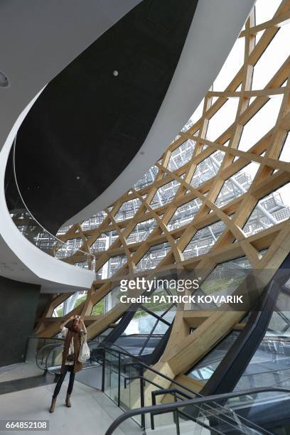 Visitor takes pictures under the dome of the new 'La Seine Musicale' cultural and musical centre, designed by architects Shigeru Ban and Jean de...