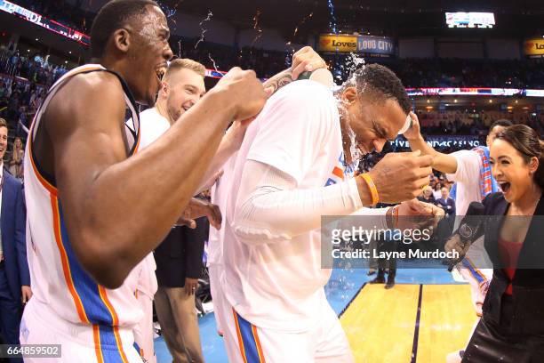 Russell Westbrook of the Oklahoma City Thunder gets water poured on him by his teammates after the game where he tied Oscar Robinson for most...