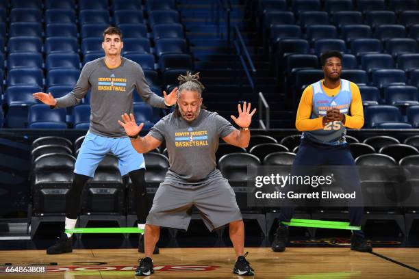 Juancho Hernangomez and Malik Beasley of the Denver Nuggets warm up before practice with strength and conditioning coach, Steve Hess on April 4, 2017...