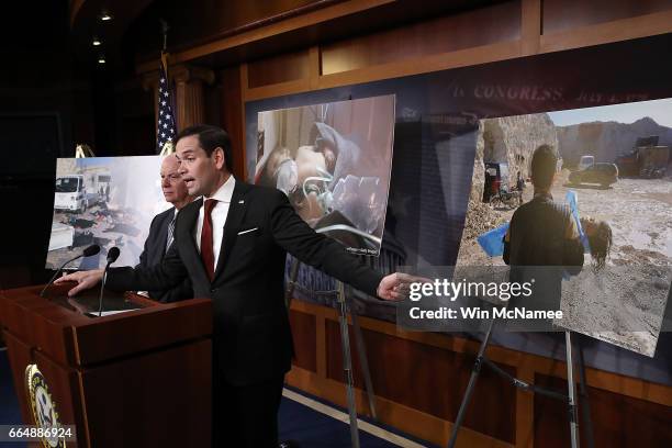 Surrounded by photographs of victims of yesterday's chemical weapon attack, Sen. Marco Rubio speaks during a press conference at the U.S. Capitol...
