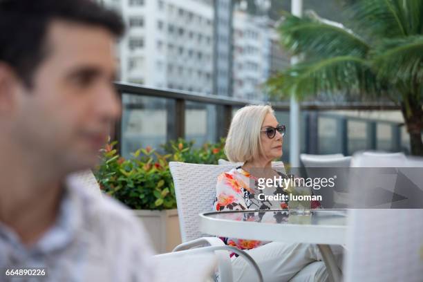 elegant old lady drinking a caipirinha - foco seletivo stock pictures, royalty-free photos & images