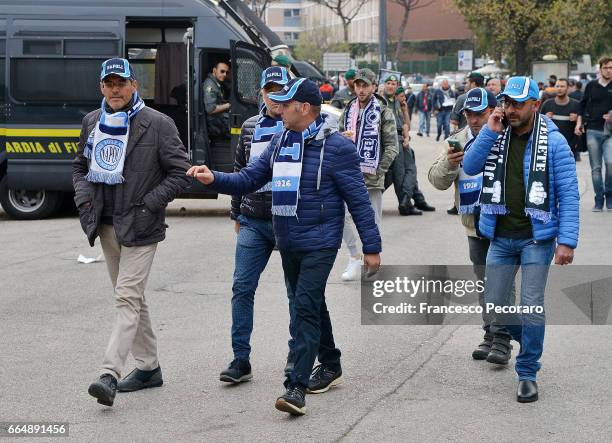 Fans of SSC Napoli walk outside the stadium before the TIM Cup match between SSC Napoli and Juventus FC at Stadio San Paolo on April 5, 2017 in...