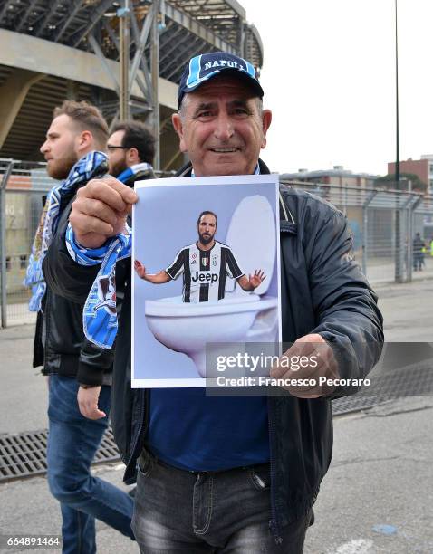 Supporter of SSC Napoli shows a banner against Gonzalo Higuain during the TIM Cup match between SSC Napoli and Juventus FC at Stadio San Paolo on...