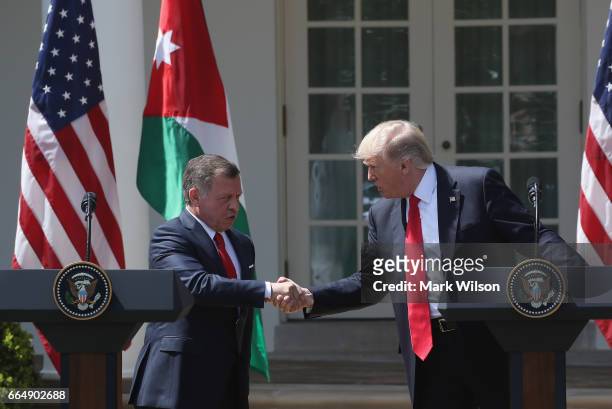 President Donald Trump and King Abdullah II of Jordan shake hands before participating in a joint news conference at the Rose Garden of the White...