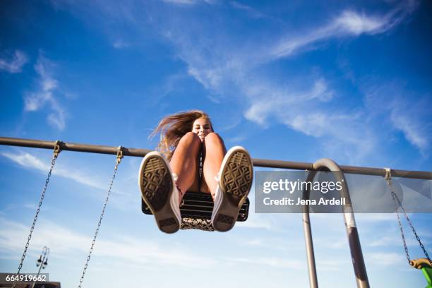 woman on swing set - blaue schuhe stock-fotos und bilder