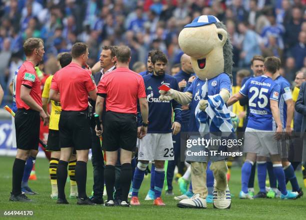 Referee, Felix Zwayer is shown a red card by the Schalke mascot, Erwin after the Bundesliga match between FC Schalke 04 and Borussia Dortmund at...