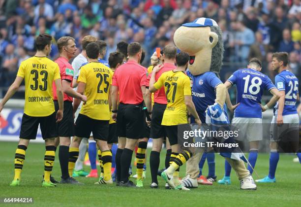 Referee, Felix Zwayer is shown a red card by the Schalke mascot, Erwin after the Bundesliga match between FC Schalke 04 and Borussia Dortmund at...