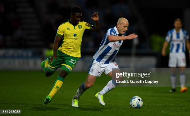 Aaron Mooy of Huddersfield gets past Alexander Tettey of Norwich during the Sky Bet Championship match between Huddersfield Town and Norwich City at...