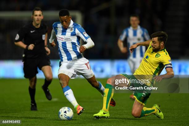 Rajiv Van La Parra of Huddersfield is tackled by Russell Martin of Norwich during the Sky Bet Championship match between Huddersfield Town and...