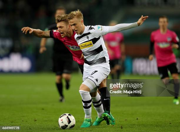 Oscar Wendt of Gladbach and Alexander Esswein of Berlin battle for the ball during the Bundesliga match between Borussia Moenchengladbach and Hertha...