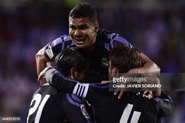 Real Madrid's Brazilian midfielder Casemiro celebrates with teammates after scoring their second goal during the Spanish league football match Club...