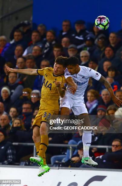 Tottenham Hotspur's Welsh defender Ben Davies vies with Swansea City's English defender Kyle Naughton during the English Premier League football...