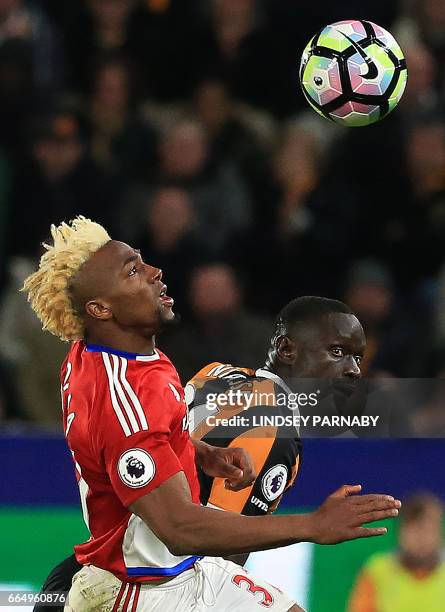 Middlesbrough's Spanish midfielder Adama Traoré vies with Hull City's Senegalese striker Oumar Niasse during the English Premier League football...