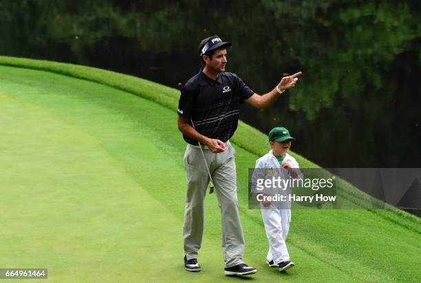 Bubba Watson of the United States and his son Caleb walk during the Par 3 Contest prior to the start of the 2017 Masters Tournament at Augusta...