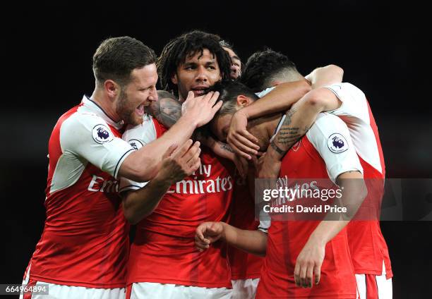 Arsenal's Mesut Ozil celebrates scoring a goal for Arsenal with Mohamed Elneny and Shkodran Mustafi during the Premier League match between Arsenal...