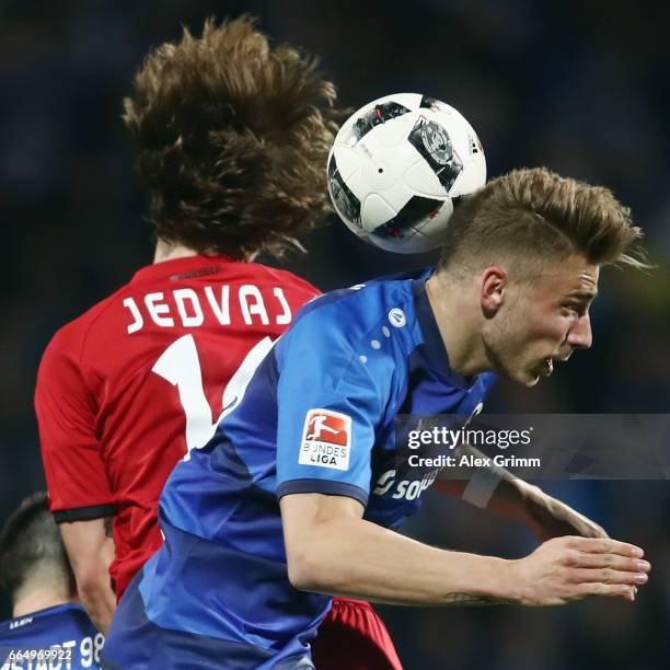 Felix Platte of Darmstadt jumps for a header with Tin Jedvaj of Leverkusen during the Bundesliga match between SV Darmstadt 98 and Bayer 04...