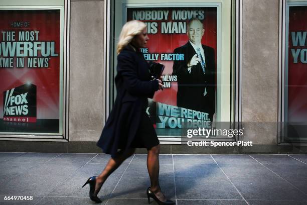 An advertisement for Bill O'Reilly's top-rated Fox News show is displayed in the window of the News Corporation headquarters on April 5, 2017 in New...