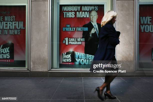 An advertisement for Bill O'Reilly's top-rated Fox News show is displayed in the window of the News Corporation headquarters on April 5, 2017 in New...